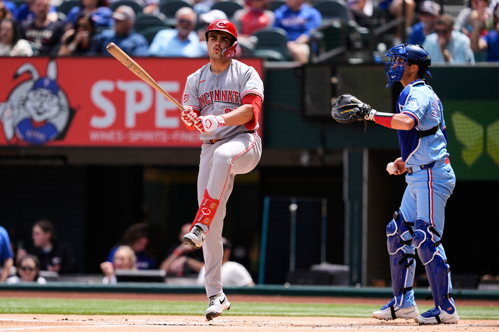 Cincinnati Reds' Sal Stewart reacts after swinging at a pitch as Texas Rangers catcher Kyle Higashioka stands by the plate in the first inning of a baseball game Sunday, April 5, 2026, in Arlington, Texas. (AP Photo/Tony Gutierrez)