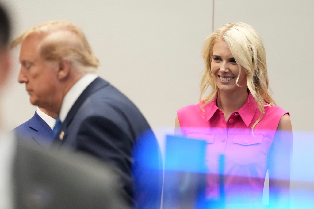White House aide Natalie Harp, right, looks after President Donald Trump, left, spoke to astronauts aboard the International Space Station, Friday, Aug. 28, 2026, at Johnson Space Center's Mission Control in Houston. (AP Photo/Mark Schiefelbein)