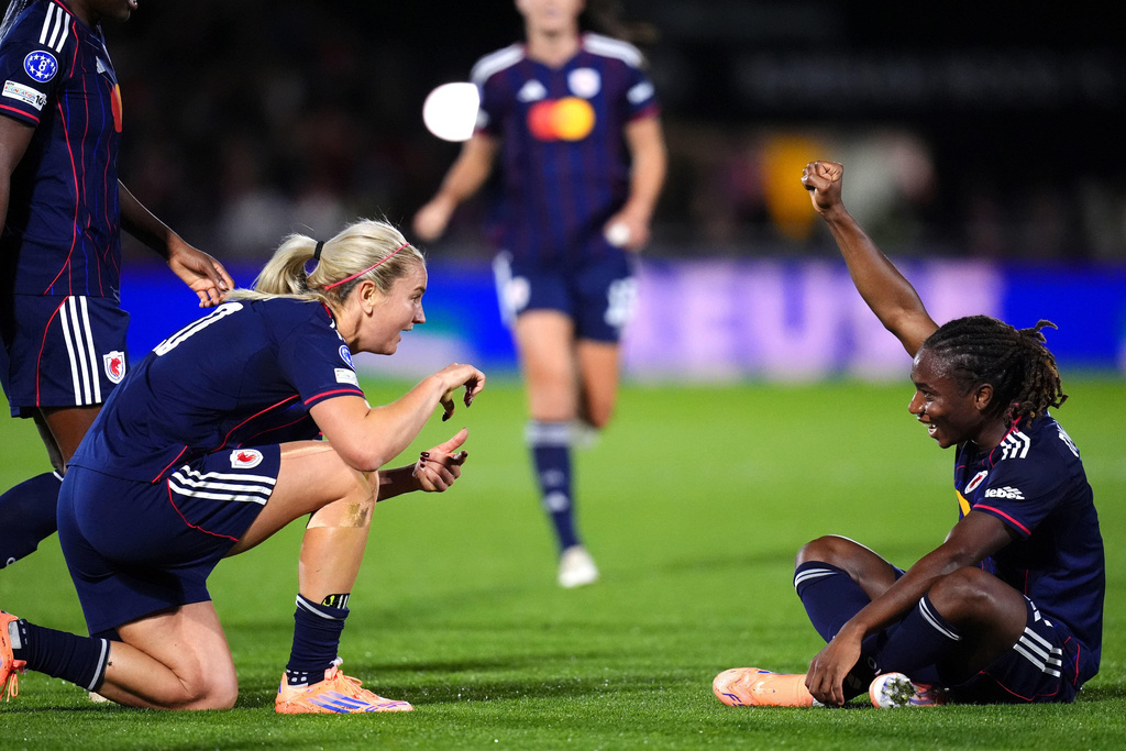 OL Lyonnes' Melchie Dumornay, right, celebrates scoring their side's second goal during the Women's Champions League soccer match between Arsenal and OL Lyonnes at Meadow Park, Borehamwood, England, Tuesday, Oct, 7, 2025. (John Walton/PA via AP)