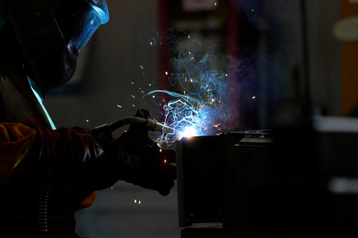 FILE -A man works at MAP, a factory operating in design, manufacture and installation of steel structures for civil and industrial use, in Corsico, near Milan, Italy, Thursday, May 12, 2022. (AP Photo/Antonio Calanni, File) FILE -A man works at MAP, a factory operating in design, manufacture and installation of steel structures for civil and industrial use, in Corsico, near Milan, Italy, Thursday, May 12, 2022. (AP Photo/Antonio Calanni, File)