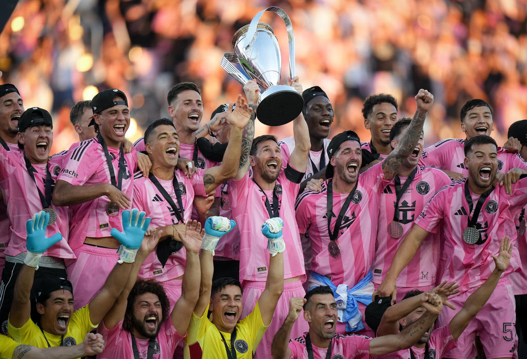 Inter Miami's Lionel Messi hoists the trophy alongside teammates after defeating the Vancouver Whitecaps in the MLS Cup final soccer match, in Fort Lauderdale, Fla., Saturday, Dec. 6, 2025. (Darryl Dyck/The Canadian Press via AP)