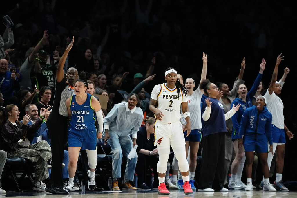 Minnesota Lynx guard Kayla McBride (21) reacts after scoring while Indiana Fever forward Myisha Hines-Allen (2) looks on during the first half of a WNBA basketball game, Thursday, Sept. 24, 2026, in Minneapolis. (AP Photo/Ellen Schmidt)
