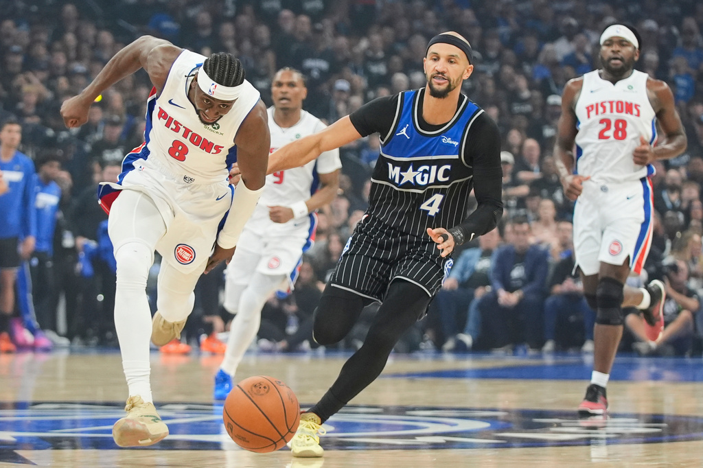 Detroit Pistons guard Caris LeVert (8) and Orlando Magic guard Jalen Suggs (4) go after a loose ball during the first half in Game 3 of a first-round NBA basketball playoff series, Saturday, April 25, 2026, in Orlando, Fla. (AP Photo/John Raoux)