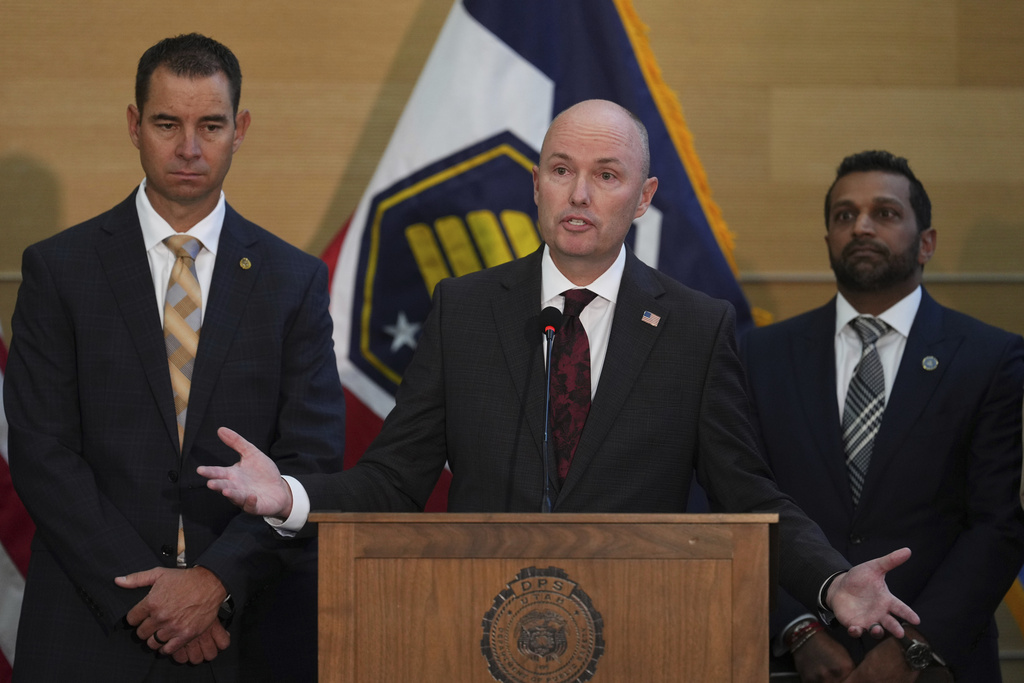 Utah Gov. Spencer Cox speaks at a news conference, as Utah department of public safety commissioner Beau Mason, left, and FBI Director Kash Patel listens, Friday, Sept. 12, 2025, in Orem, Utah. (AP Photo/Lindsey Wasson)