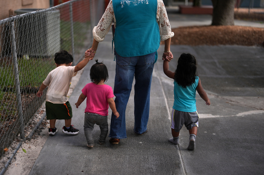 A teacher escorts young children back to their classroom at a Head Start preschool in Immokalee, Fla., Thursday, Sept. 10, 2026. (AP Photo/Rebecca Blackwell)