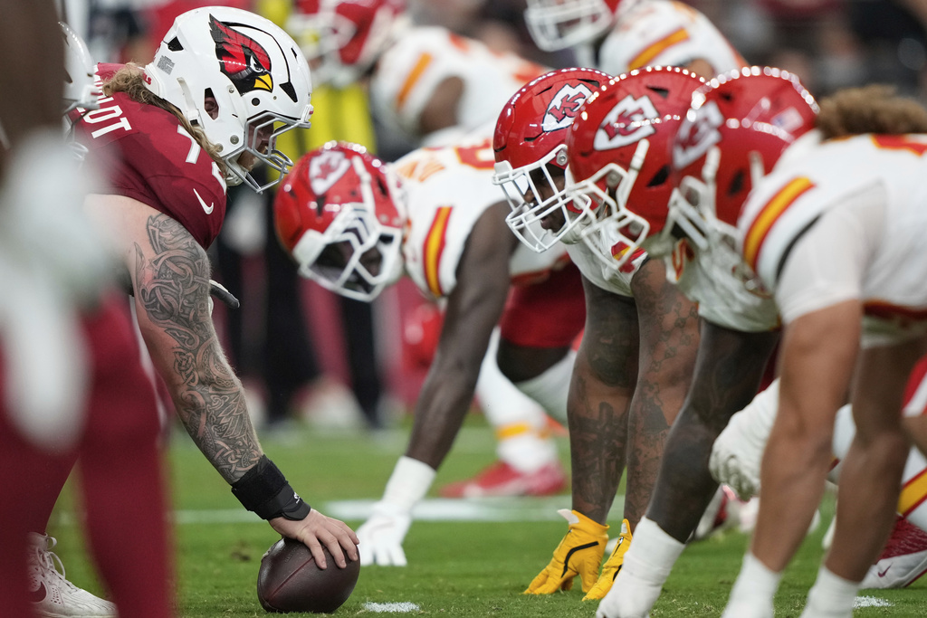 The Kansas City Chiefs line up as Arizona Cardinals guard Hjalte Froholdt (72) prepares to snap the ball during the first half of an NFL preseason football game, Saturday, Aug. 9, 2025, in Glendale. (AP Photo/Doug Benc)