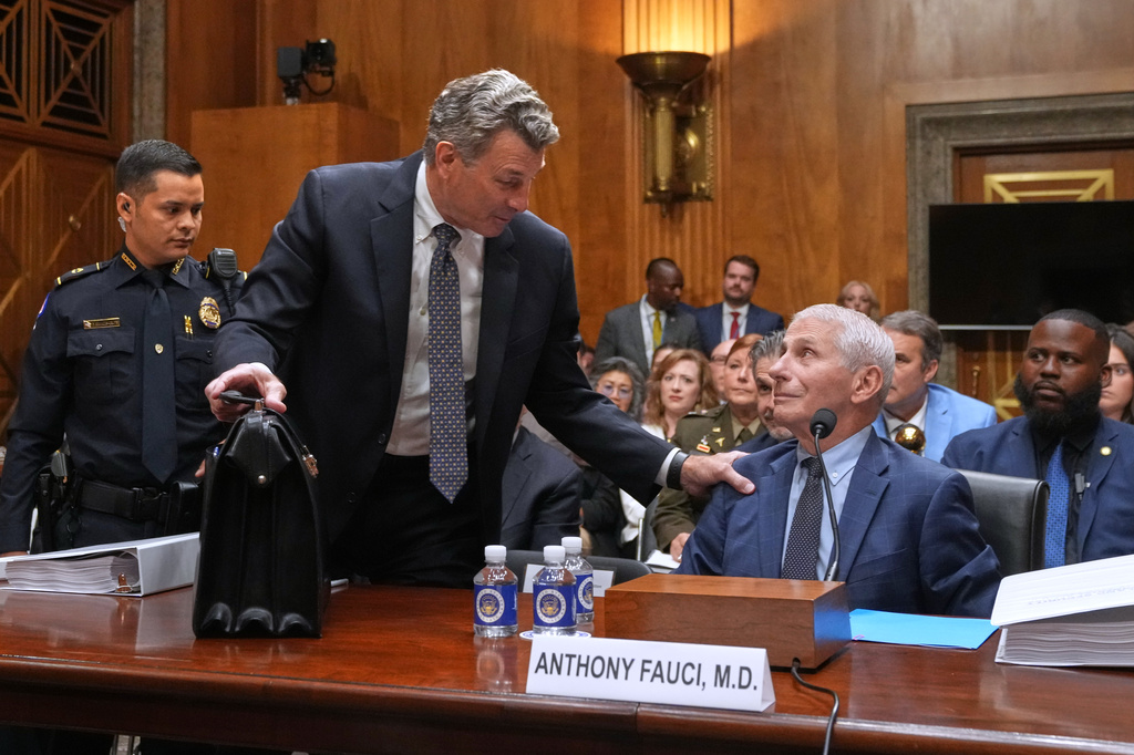 David Schertler, Dr. Anthony Fauci's defense lawyer, is escorted out, as Fauci appears before the Senate Homeland Security and Governmental Affairs Committee at the Capitol, Wednesday, July 29, 2026, in Washington. (AP Photo/Allison Robbert)