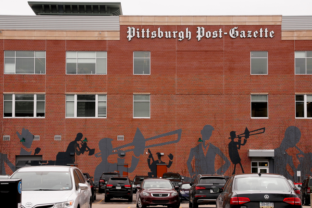 FILE - Cars are parked near the building where the offices of the Pittsburgh Post-Gazette on Feb. 14, 2019, in Pittsburgh. (AP Photo/Keith Srakocic, File)