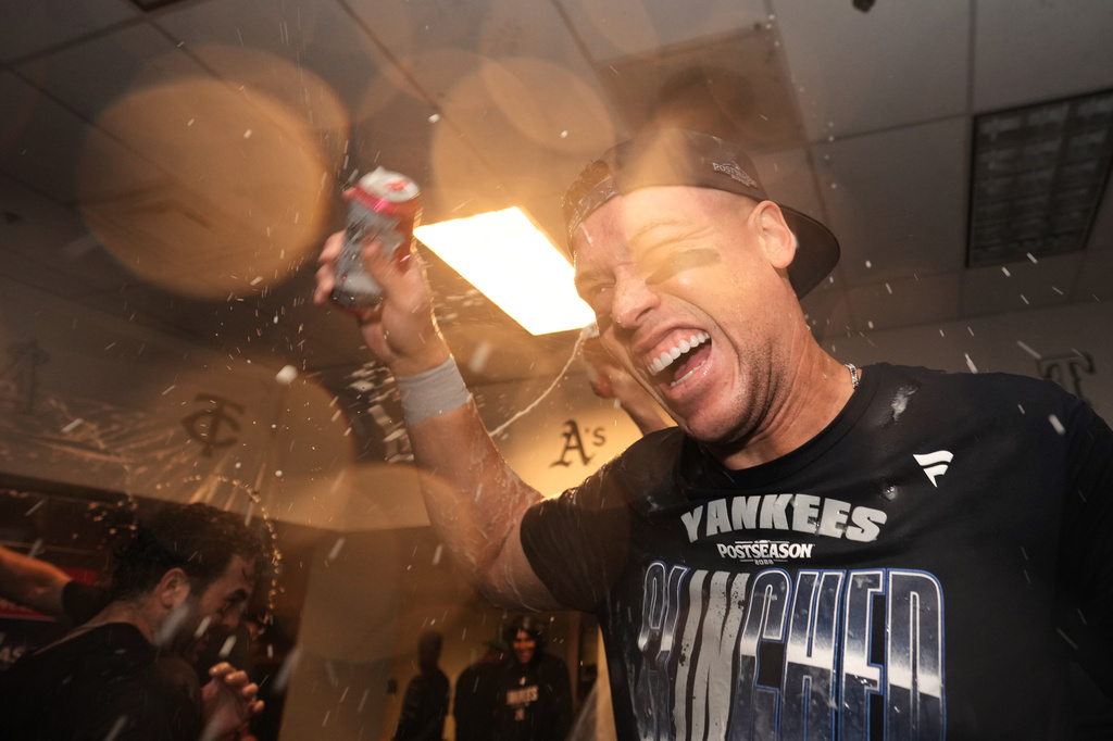 New York Yankees' Aaron Judge, center, celebrates with teammates after they clinched the playoffs in a baseball game against the Minnesota Twins, Monday, Sept. 14, 2026, in Minneapolis. (AP Photo/Abbie Parr)