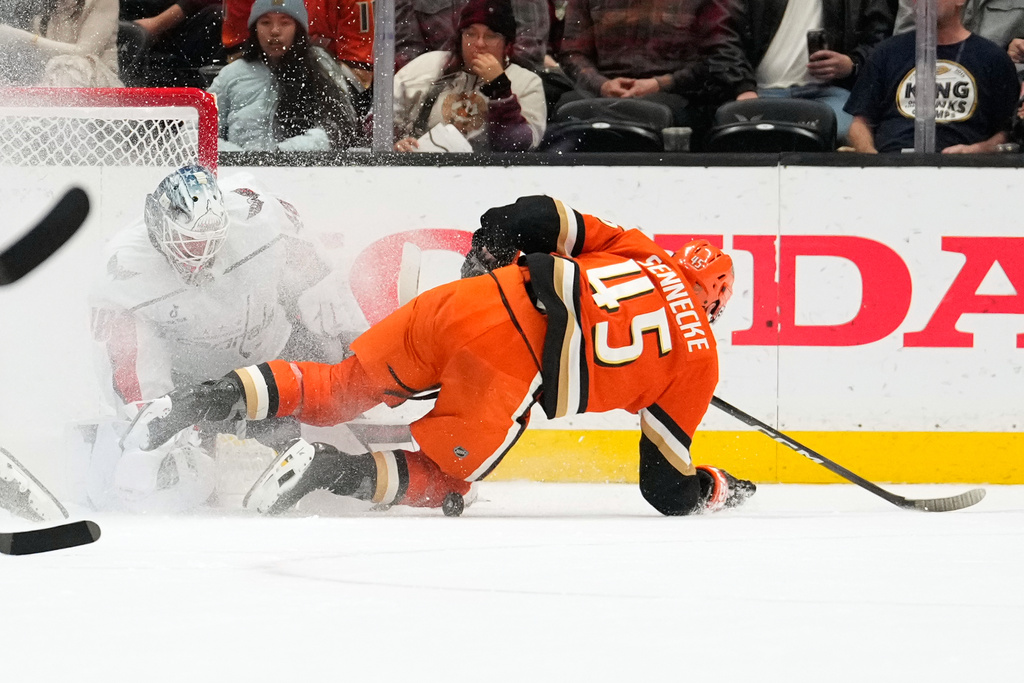 Anaheim Ducks right wing Beckett Sennecke, right, tries to score on Washington Capitals goaltender Logan Thompson during the second period of an NHL hockey game Friday, Dec. 5, 2025, in Anaheim, Calif. (AP Photo/Mark J. Terrill)