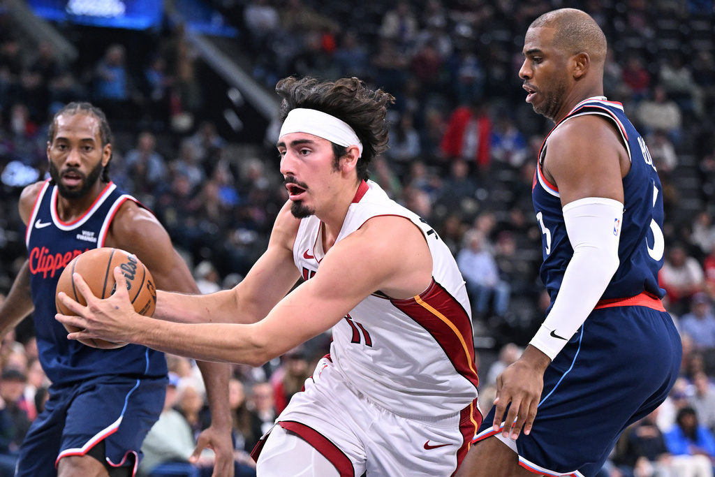 Miami Heat guard Jaime Jaquez Jr. drives past Los Angeles Clippers guard Chris Paul, right, during the first half of an NBA basketball game Monday, Nov. 3, 2025, in Los Angeles. (AP Photo/Wally Skalij)