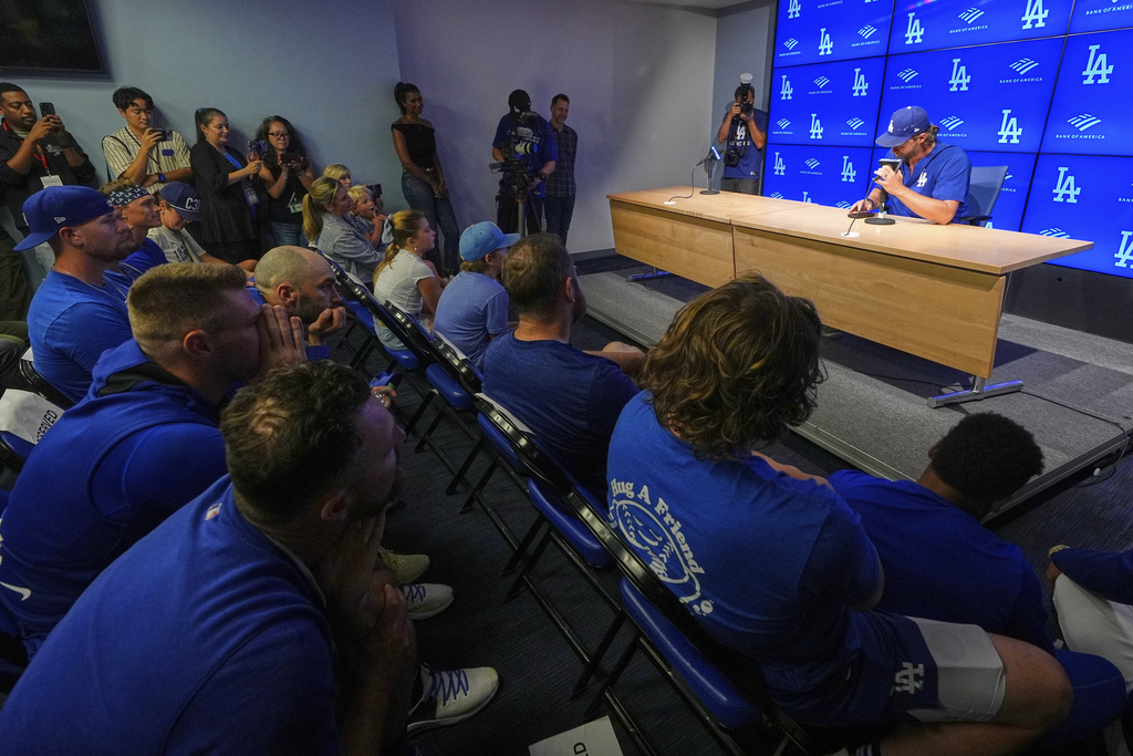 Los Angeles Dodgers pitcher Clayton Kershaw speaks to the media as members of the team and his family listen after announcing his retirement at the end of the season prior to a baseball game against the Philadelphia Phillies Thursday, Sept. 18, 2025, in Los Angeles. (AP Photo/Mark J. Terrill)