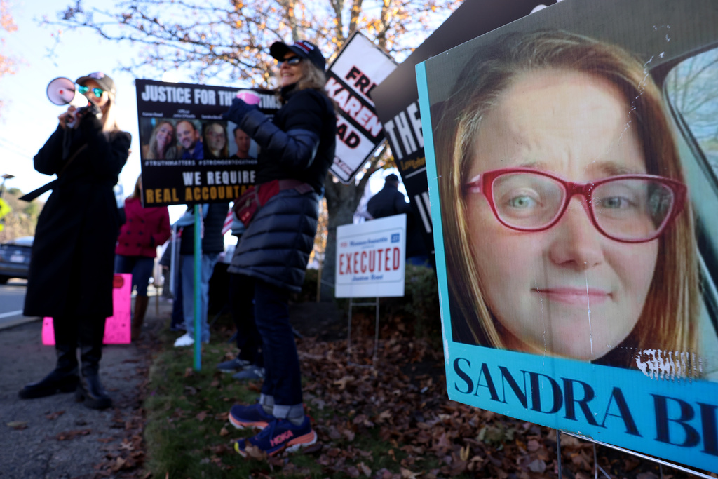 A photo of Sandra Birchmore is displayed during a Stronger Together Standout gathering, where the groups Free Karen Read, Justice for Sandra Birchmore & Justice for Juston Root protested together, outside of the Norfolk District Attorney's office, Nov. 13, 2024, in Canton, Mass. (Jessica Rinaldi/The Boston Globe via AP, File)