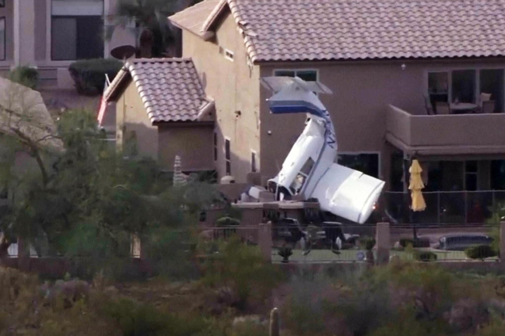 This image made from video provided by ABC15 Arizona shows a small plane that landed nose-down in a backyard, in north Phoenix, Wednesday, March 4, 2026. (ABC15 Arizona via AP)