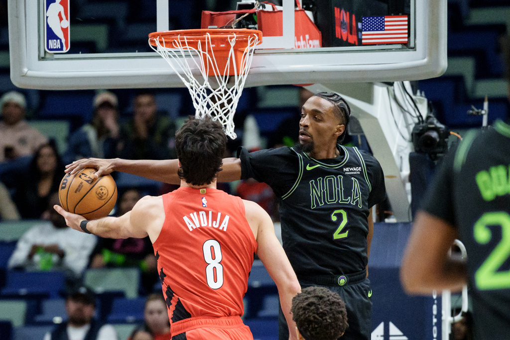 New Orleans Pelicans forward Herbert Jones (2) blocks the shot of Portland Trail Blazers forward Deni Avdija (8) during the first half of an NBA basketball game in New Orleans, Thursday, Dec. 11, 2025. (AP Photo/Matthew Hinton)