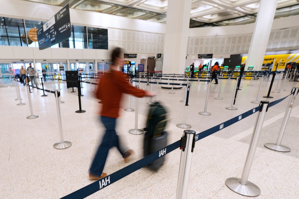 A traveler walks through TSA security lines at George Bush Intercontinental Airport on Monday, March 30, 2026, in Houston. (AP Photo/Ashley Landis)