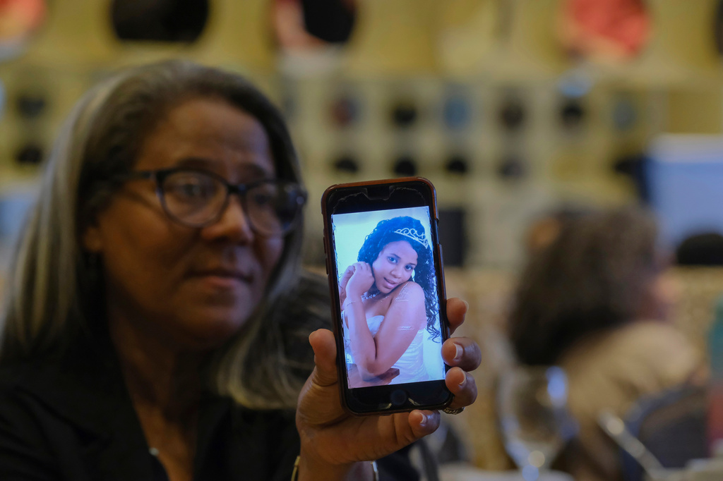FILE - Rosa Hernández shows a photo of her late daughter Rosaura Almonte in Santo Domingo, Dominican Republic, Dec. 10, 2023. Hernández asked for an exception for her daughter to get an abortion in order to use chemotherapy as her leukemia treatment, but was denied because that would put the fetus at risk of death in the Dominican Republic where abortion is criminalized without exceptions. Both her daughter and daughter's 3-week-old fetus died in 2012. CORRECTION: Corrects from 13-week-old fetus to 3-week-old fetus. (AP Photo/Ricardo Hernandez, File)
