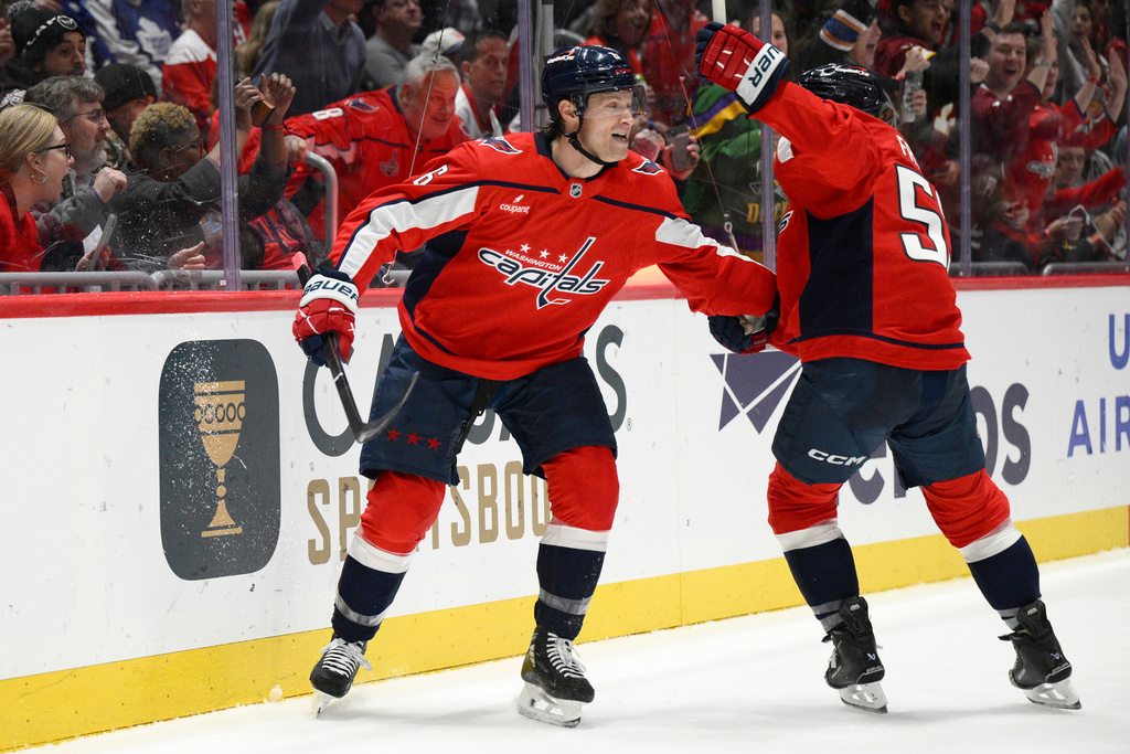 Washington Capitals defenseman Jakob Chychrun, left, celebrates his goal with center Ethen Frank during the first period of an NHL hockey game against the Toronto Maple Leafs, Thursday, Dec. 18, 2025, in Washington. (AP Photo/Nick Wass)