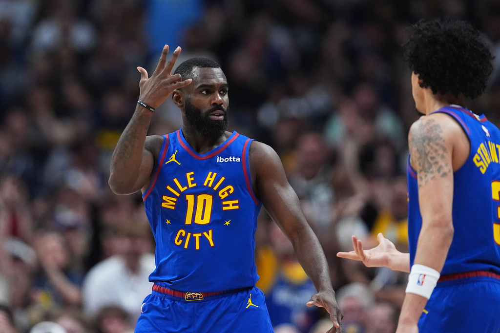 Denver Nuggets guard Tim Hardaway Jr., left, gestures after hitting a 3-point basket as guard Julian Strawther looks on in the second half of an NBA basketball game against the Golden State Warriors Sunday, March 29, 2026, in Denver. (AP Photo/David Zalubowski)