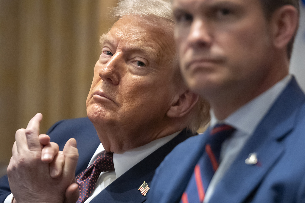 President Donald Trump, left, and Defense Secretary Pete Hegseth listen during a cabinet meeting at the White House, Tuesday, Aug. 26, 2025, in Washington. (AP Photo/Mark Schiefelbein)