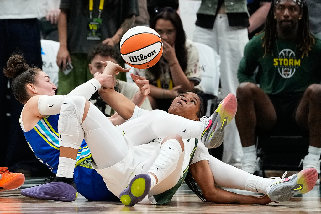 Dallas Wings forward Jessica Shepard and Seattle Storm guard Zia Cooke struggle for the ball during overtime in a WNBA basketball game, Monday, June 22, 2026, in Seattle. (AP Photo/Lindsey Wasson)