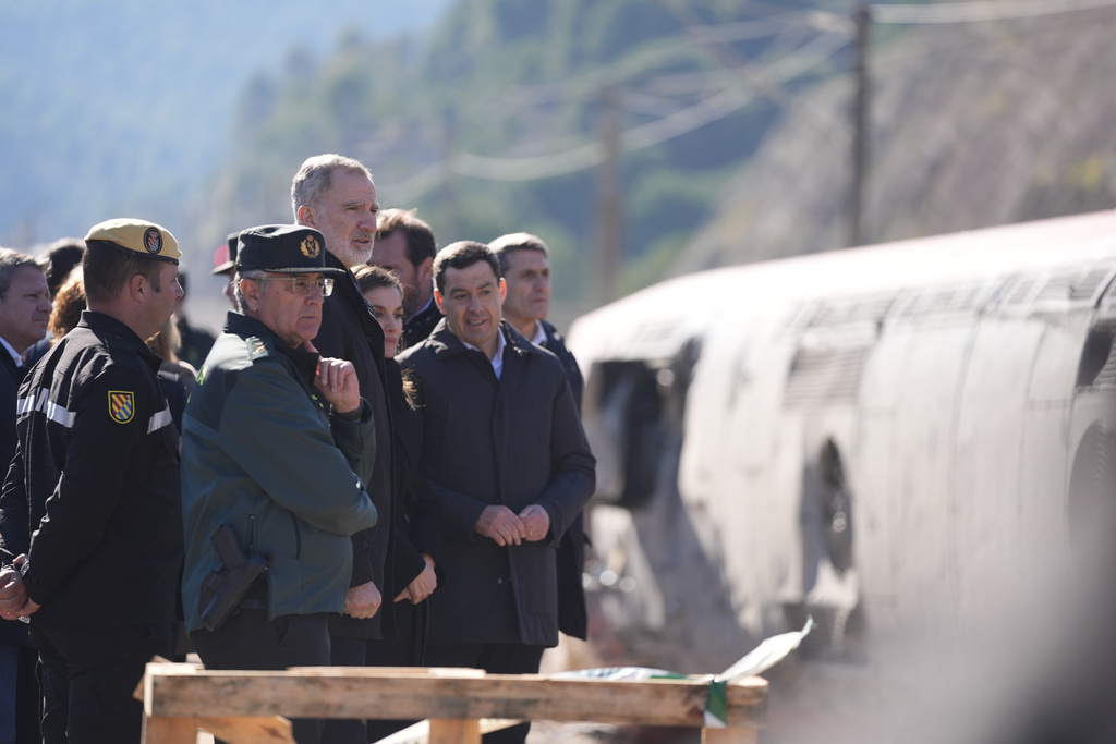 Spain's King Felipe VI and Queen Letizia visit the site of a train collision in Adamuz, southern Spain, Tuesday, Jan. 20, 2026. (Joaquin Corchero/Europa Press via AP) **SPAIN OUT**