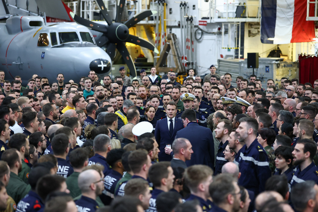 French President Emmanuel Macron sings the national anthem with the crew as he visits the French aircraft carrier Charles de Gaulle, during his visit to Cyprus, Monday March 9, 2026. (Gonzalo Fuentes/Pool Photo via AP)