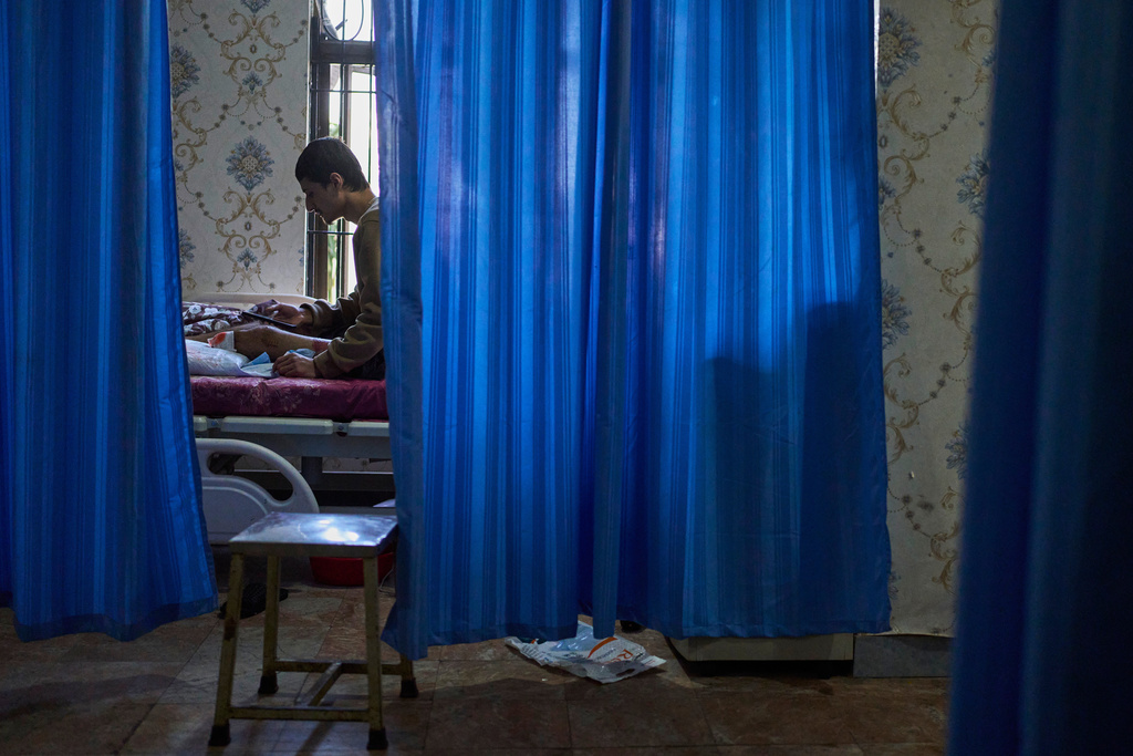 Mukesh Awasti, 22, who took part in September protests against corruption in Nepal and lost his leg after being shot by security forces, lies on a hospital bed during treatment in Kathmandu, Nepal, on Dec. 8, 2025. (AP Photo/Niranjan Shrestha)