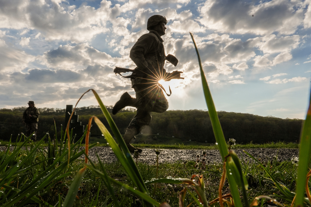 A cadet runs to shoot an M4 service rifle during the Sandhurst Military Skills Competition at the United States Military Academy in West Point, N.Y., Saturday, May 2, 2026. (AP Photo/Julia Demaree Nikhinson)