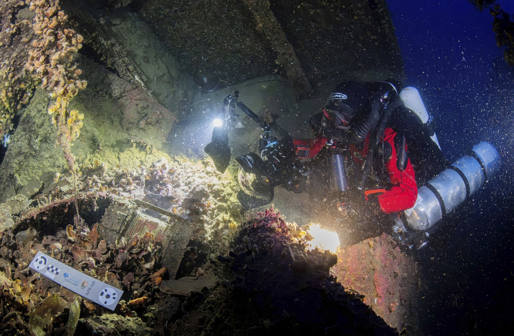 In this undated photo provided by the Greek Culture Ministry on Monday, Sept. 15, 2025, divers illuminate the wreck's interior of the Britannic, sister ship to the Titanic, for the first time since the ocean liner sank in the Aegean Sea more than a century ago after striking a mine during World War I. (Greek Culture Ministry via AP)
