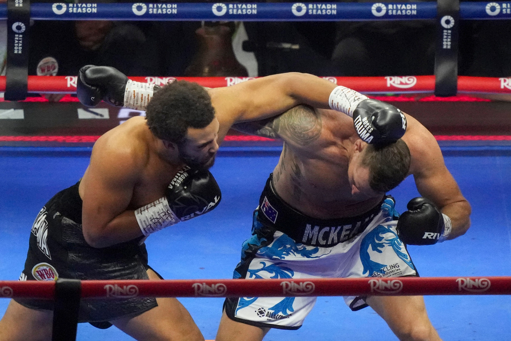 FILE - Britain's Moses Itauma, left, lands a blow on Australia's Demsey McKean in their heavyweight boxing fight in Riyadh, Saudi Arabia, Saturday, Dec. 21, 2024. (AP Photo/Frank Augstein, File)