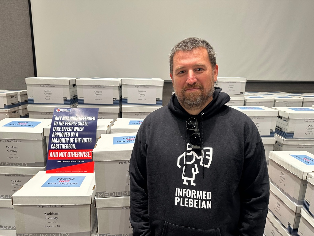 Richard von Glahn, executive director of People Not Politicians, stands alongside boxes of petition signatures submitted Tuesday, Dec. 9, 2025, to the secretary of state's office in Jefferson City, Mo. calling for a referendum election on new U.S. House districts approved by the Missouri legislature. (AP Photo/David A. Lieb)