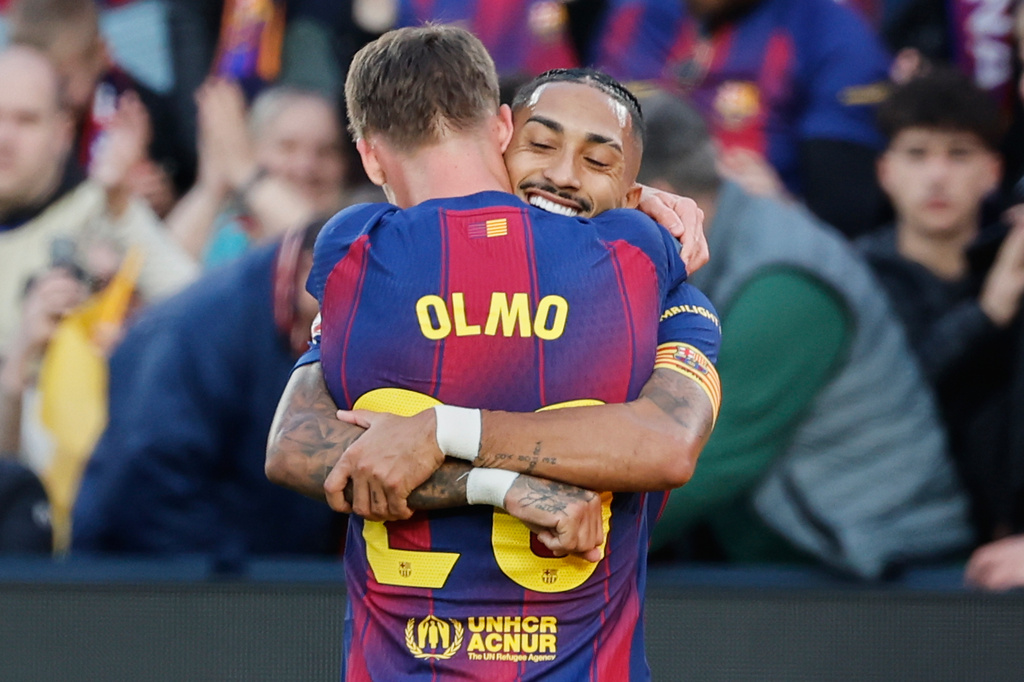 Barcelona's Dani Olmo, back, celebrates after scoring his side's second goal during a Spanish La Liga soccer match between Barcelona and Alaves, in Barcelona, Spain, Saturday, Nov. 29, 2025. (AP Photo/Joan Monfort)