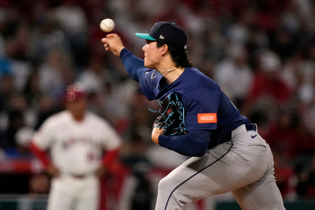 Seattle Mariners starting pitcher Bryan Woo throws to the plate during the second inning of an opening-day baseball game against the Los Angeles Angels, Friday, April 3, 2026, in Anaheim, Calif. (AP Photo/Mark J. Terrill)