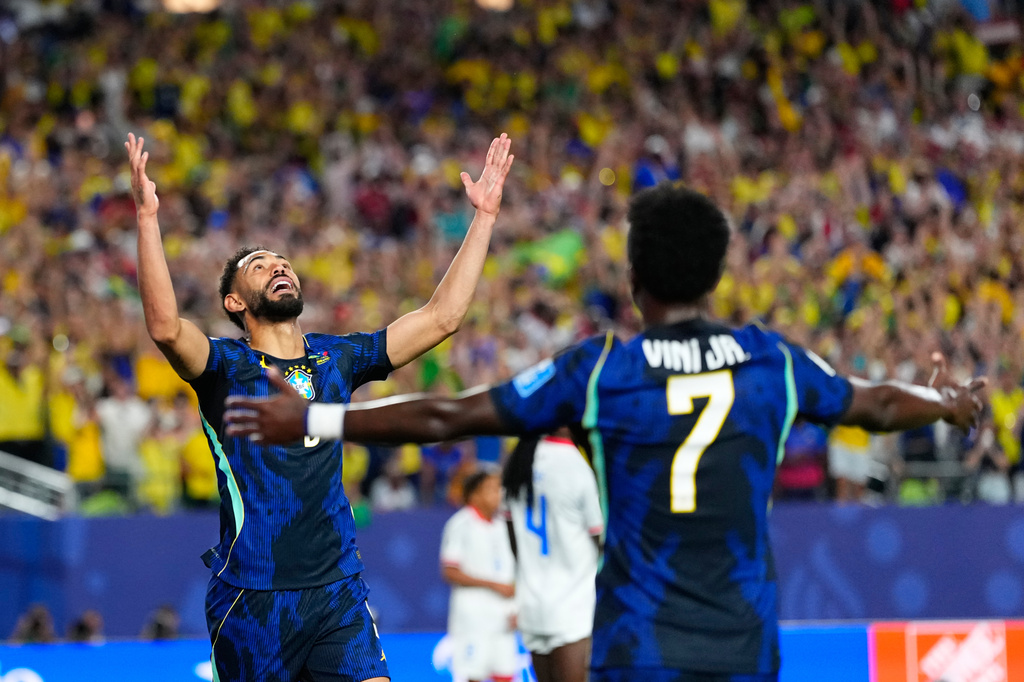 Brazil's Matheus Cunha (9) celebrates after scoring his side's opening goal with Brazil's Vinicius Junior (7) during the World Cup Group C soccer match between Brazil and Haiti in Philadelphia, Friday, June 19, 2026. (AP Photo/Petr David Josek)