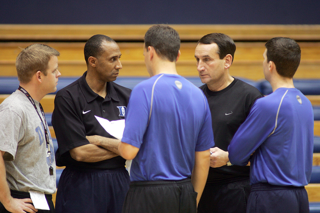 FILE - Duke basketball coach Mike Krzyzewski, center right, speaks with his assistant coaches Steve Wojciechowski, left, Johnny Dawkins, center left, Chris Collins, center, and Graduate Assistant Chris Spatola, right, during practice in Durham, N.C., on Oct. 26, 2007. (AP Photo/Jim Bounds, File)