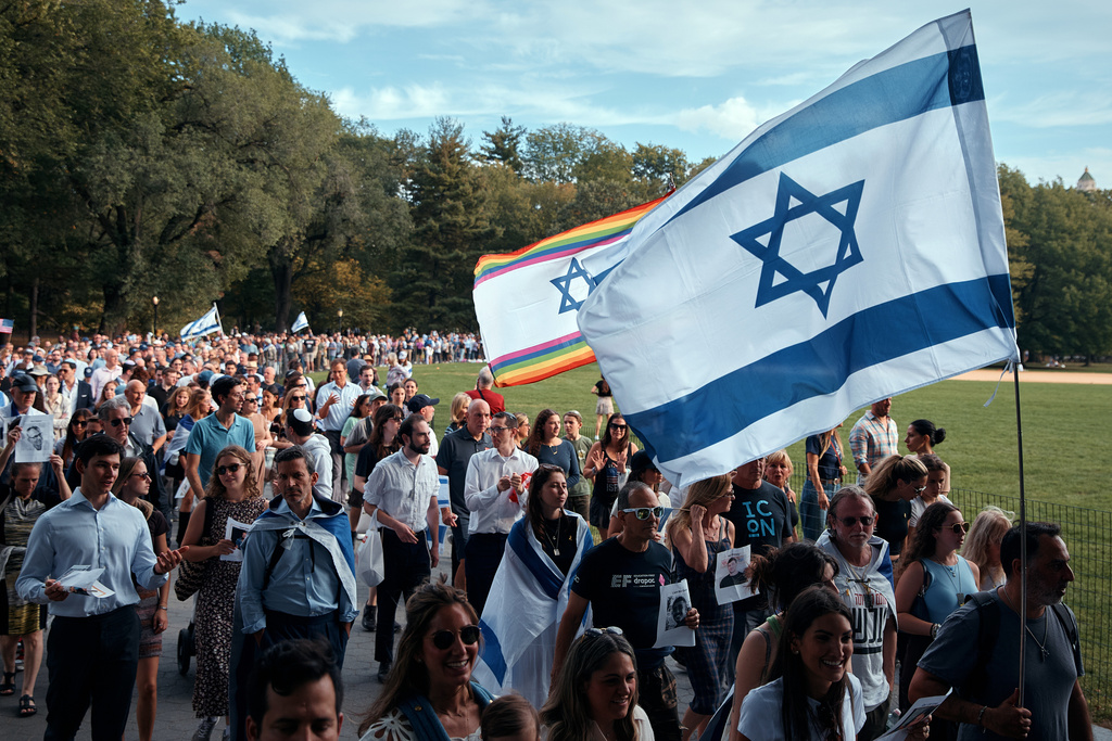 Jews march around the Great Lawn in Manhattan's Central Park for a "Circle of Unity" event marking the second anniversary of the deadly Oct. 7 attack in Israel, on Tuesday, Oct. 7, 2025, in New York. (AP Photo/Andres Kudacki)