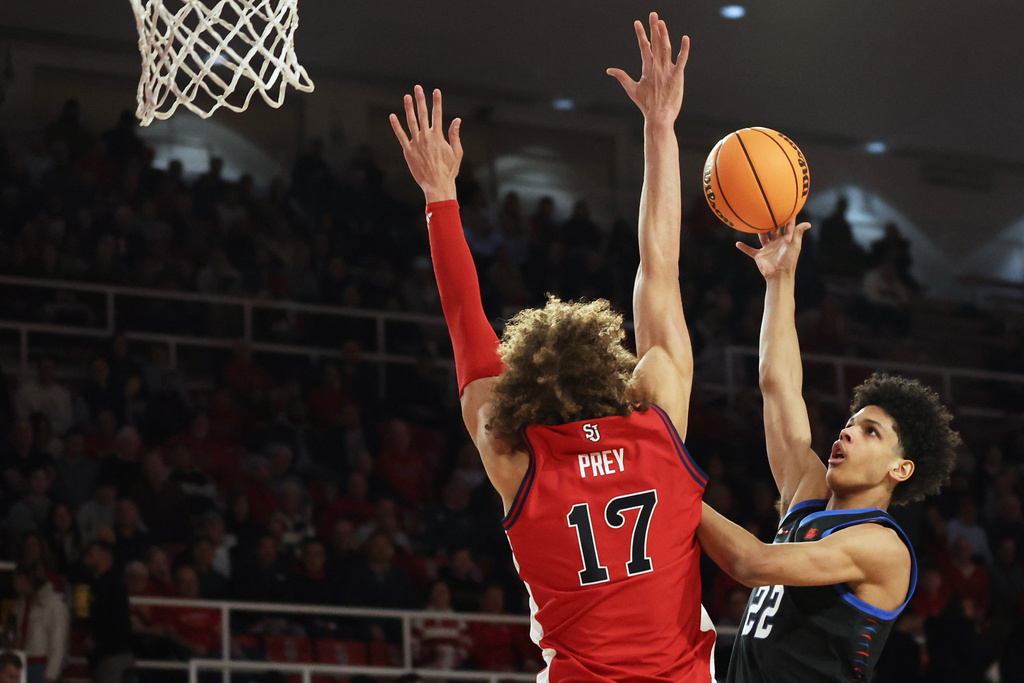 DePaul guard Kruz McClure (22) shoots over St. John's forward Rubén Prey (17) during the first half of an NCAA college basketball game, Tuesday, Dec. 16, 2025, in New York. (AP Photo/Heather Khalifa)