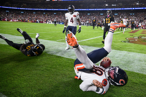 Washington Commanders safety Quan Martin (20) rolls through the play Chicago Bears quarterback Caleb Williams (18) as Williams scores a touchdown during the first half of an NFL football game Monday, Oct. 13, 2025, in Landover, Md. (AP Photo/Nick Wass) Washington Commanders safety Quan Martin (20) rolls through the play Chicago Bears quarterback Caleb Williams (18) as Williams scores a touchdown during the first half of an NFL football game Monday, Oct. 13, 2025, in Landover, Md. (AP Photo/Nick Wass)