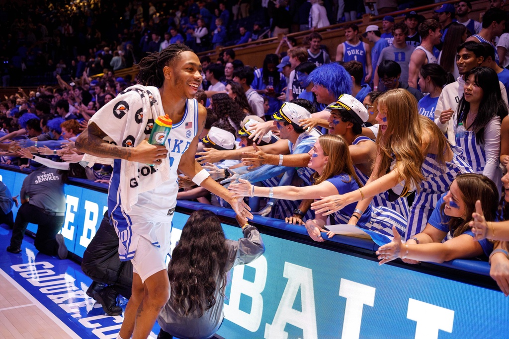 Duke's Isaiah Evans, left, slaps hands with fans after his team defeated Indiana State in an NCAA college basketball game in Durham, N.C., Friday, Nov. 14, 2025. (AP Photo/Ben McKeown)
