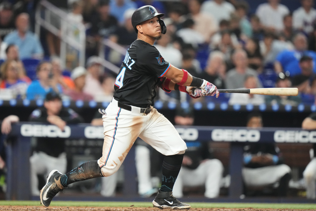 Miami Marlins' Heriberto Hernandez watches after hitting a RBI triple to score Griffin Conine and Troy Johnston during the fifth inning of a baseball game against the New York Mets, Friday, Sept. 26, 2025, in Miami. (AP Photo/Lynne Sladky)