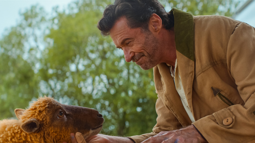 This image released by Amazon MGM Studios shows sheep character Lily, voiced Julia-Louis Dreyfus, left, with Hugh Jackman as George Hardy, in a scene from "The Sheep Detectives." (Amazon MGM Studios via AP)
