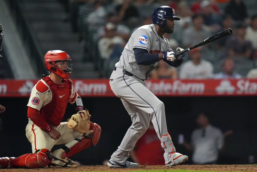 Houston Astros' Yordan Alvarez (44) watches his go-ahead RBI single against the Los Angeles Angels during the ninth inning of a baseball game Tuesday, July 28, 2026, in Anaheim, Calif. (AP Photo/Scott Strazzante)