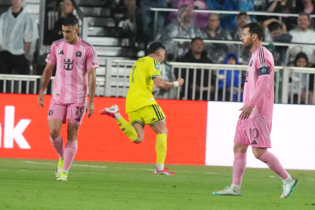 Inter Miami forwards Germán Berterame (19) and Lionel Messi (10) react as Nashville forward Cristian Espinoza (7) celebrates his goal during the second half of a CONCACAF Champions Cup Round of 16 soccer match, Wednesday, March 18, 2026, in Fort Lauderdale, Fla. (AP Photo/Marta Lavandier)