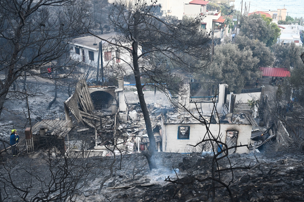 A home is in ruins after it was burned by a wildfire on the island of Salamina, west of Athens, Greece, Sunday, Aug. 16, 2026. (AP Photo/Michael Varaklas)