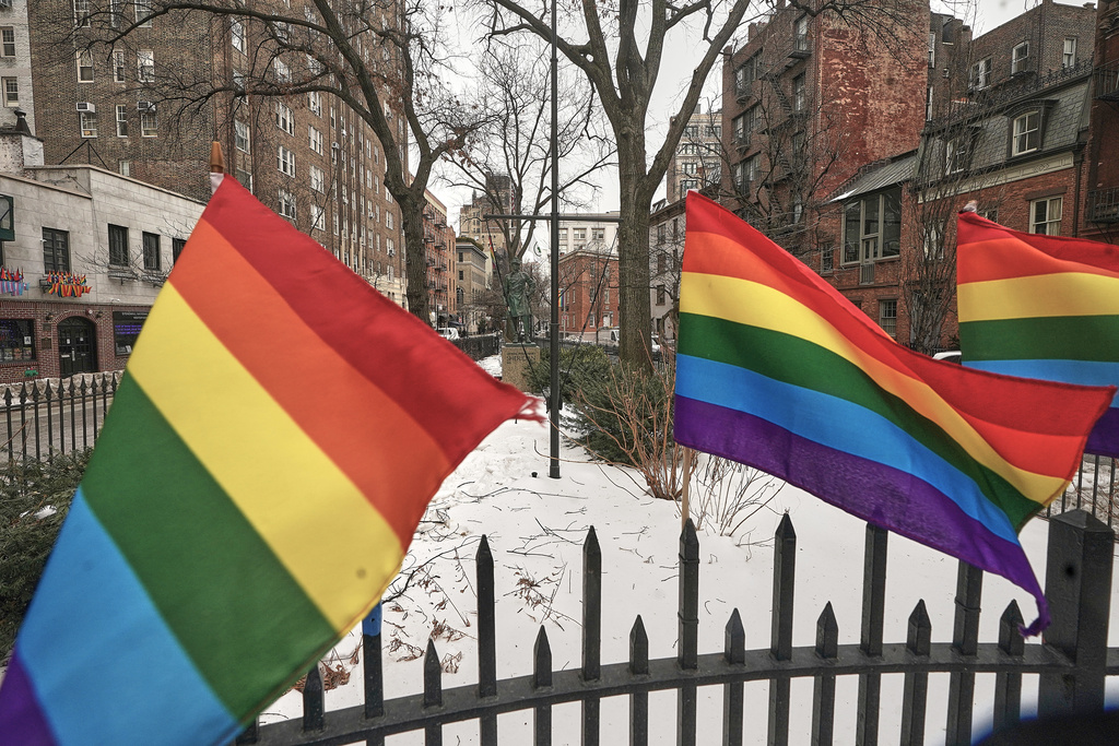 Small Pride flags adorn a fence in the Stonewall National Monument while the Trump administration has stopped flying a rainbow flag on the pole, center, in New York, Tuesday, Feb. 10, 2026. (AP Photo/Richard Drew)