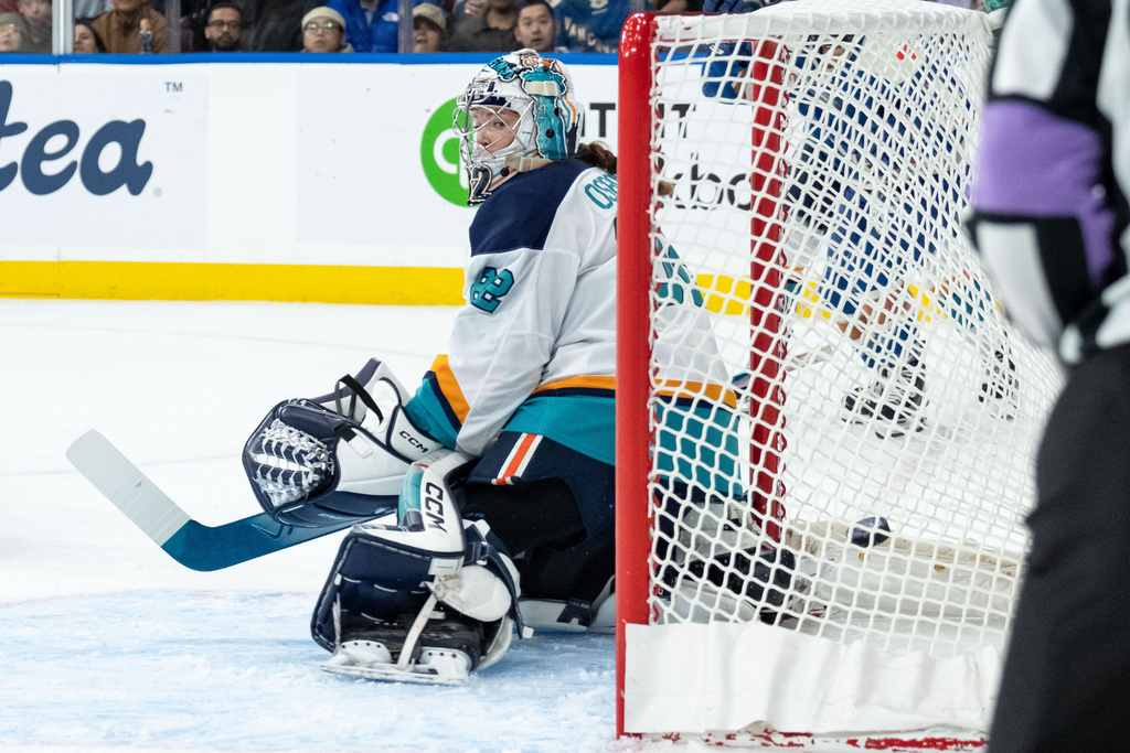 Vancouver Goldeneyes' Anna Segedi, not seen, scores on New York Sirens goaltender Kayle Osborne (82) during the first period of a PWHL hockey game in Vancouver, on Wednesday, March 18, 2026. (Ethan Cairns/The Canadian Press via AP)