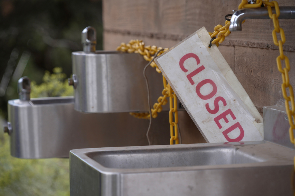 A sign is seen as officials at Grand Canyon National Park in northern Arizona have closed off access to water sources at the park after a flash flood damaged the only water pipeline that serves the canyon, Monday, Aug. 31, 2026. (AP Photo/Ty ONeil)