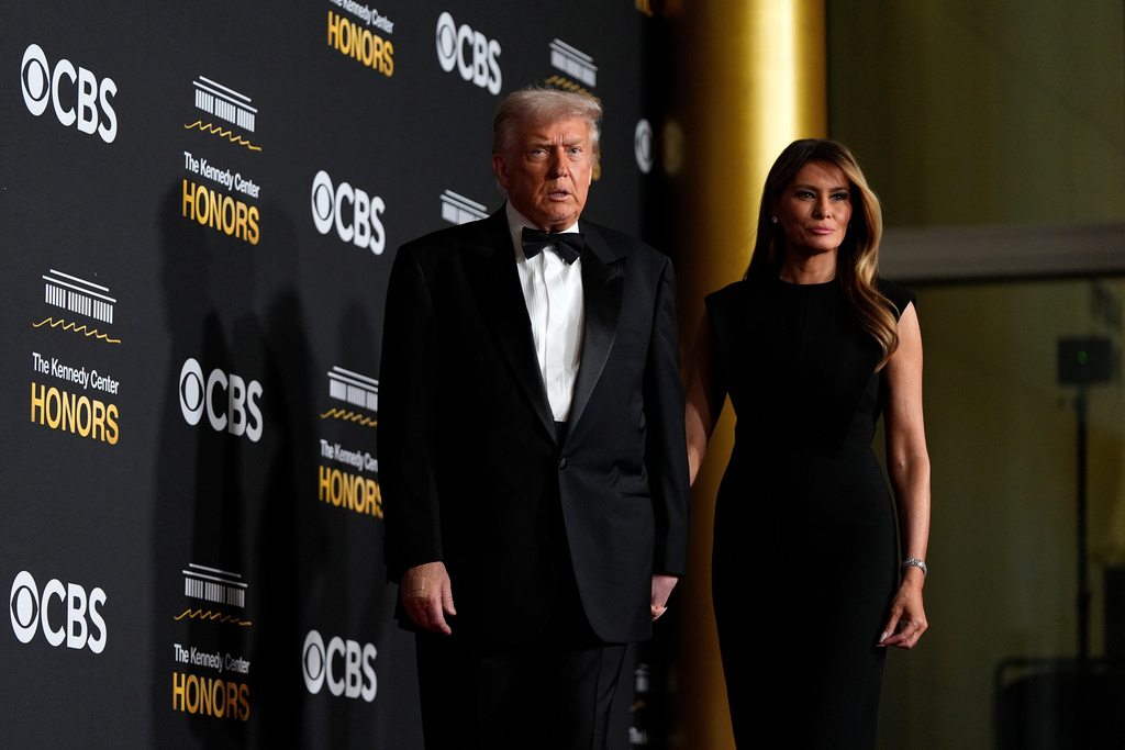 President Donald Trump and first lady Melania Trump, walk the red carpet before the 48th Kennedy Center Honors, Sunday, Dec. 7, 2025, at the John F. Kennedy Center for the Performing Arts in Washington. (AP Photo/Julia Demaree Nikhinson)