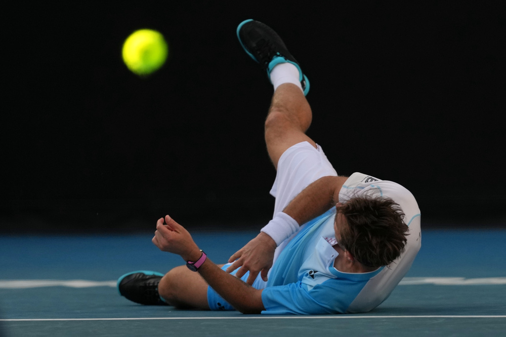 Stan Wawrinka of Switzerland falls during his second round match against Arthur Gea of France at the Australian Open tennis championship in Melbourne, Australia, Thursday, Jan. 22, 2026. (AP Photo/Dita Alangkara)